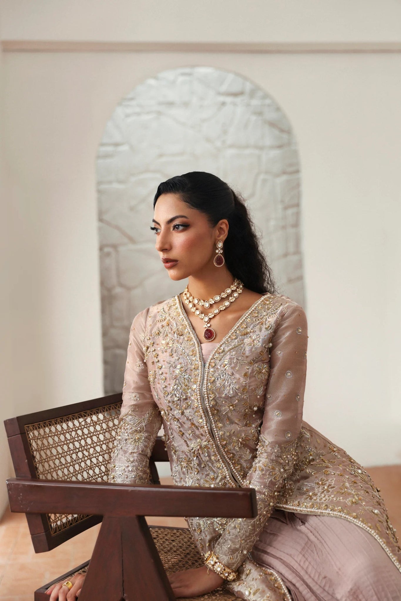 Model wearing Yara from Mysie by Tahira in a blush pink heavily embellished formal dress with pleated lehenga. Pakistani wedding clothes online in UK.