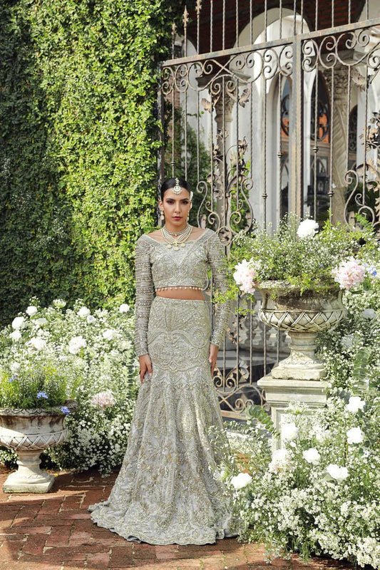 Model wearing Mist from Mysie by Tahira's Arzu Bridals '24 collection in light grey. Wedding wear, bridal, Pakistani clothes online in UK.