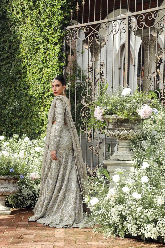 Model wearing Mist from Mysie by Tahira's Arzu Bridals '24 collection in light grey. Wedding wear, bridal, Pakistani clothes online in UK.