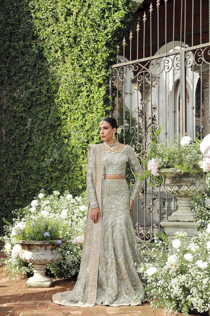 Model wearing Mist from Mysie by Tahira's Arzu Bridals '24 collection in light grey. Wedding wear, bridal, Pakistani clothes online in UK.