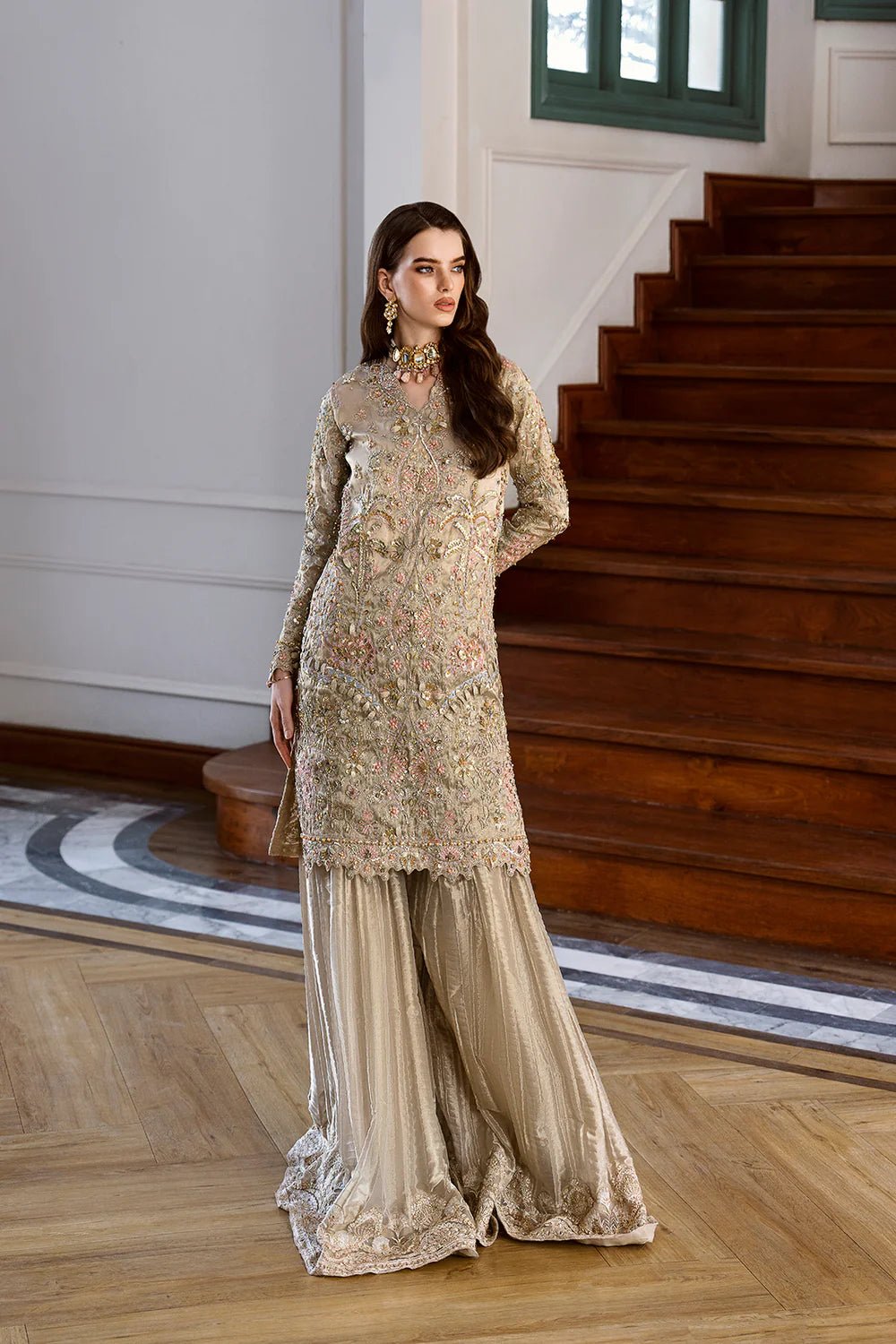 Model in gold Rameen dress from Mysie by Tahira Eid Pret '24, a highlight of Pakistani elegance in the UK.