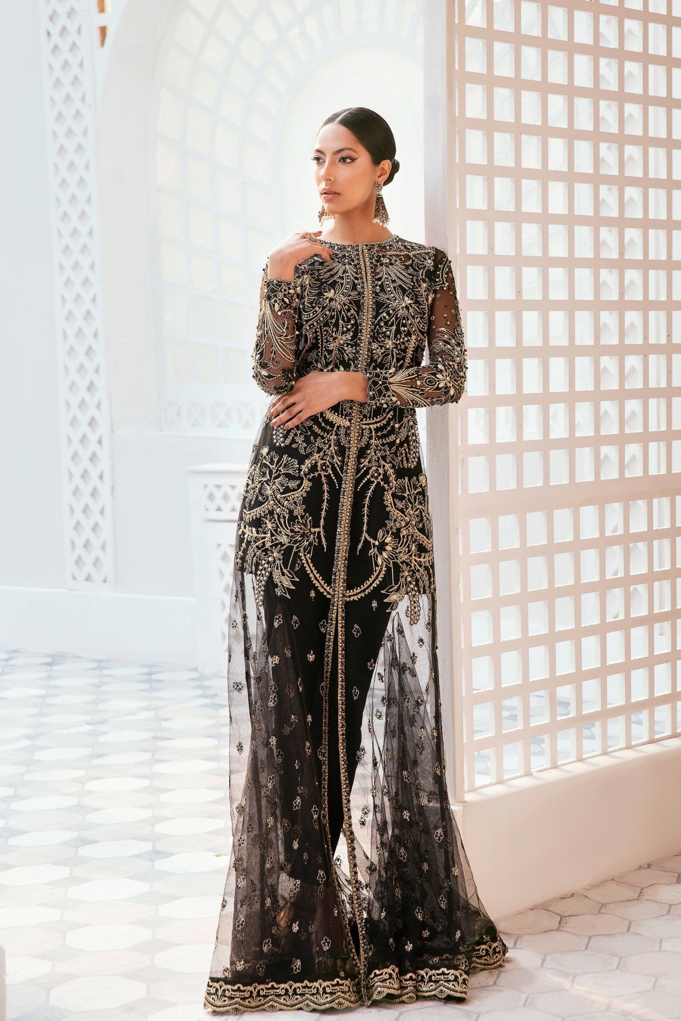 Model wearing a black wedding dress by Mysie by Tahira, adorned with intricate embellishments, ideal for Pakistani weddings, available online in the UK.