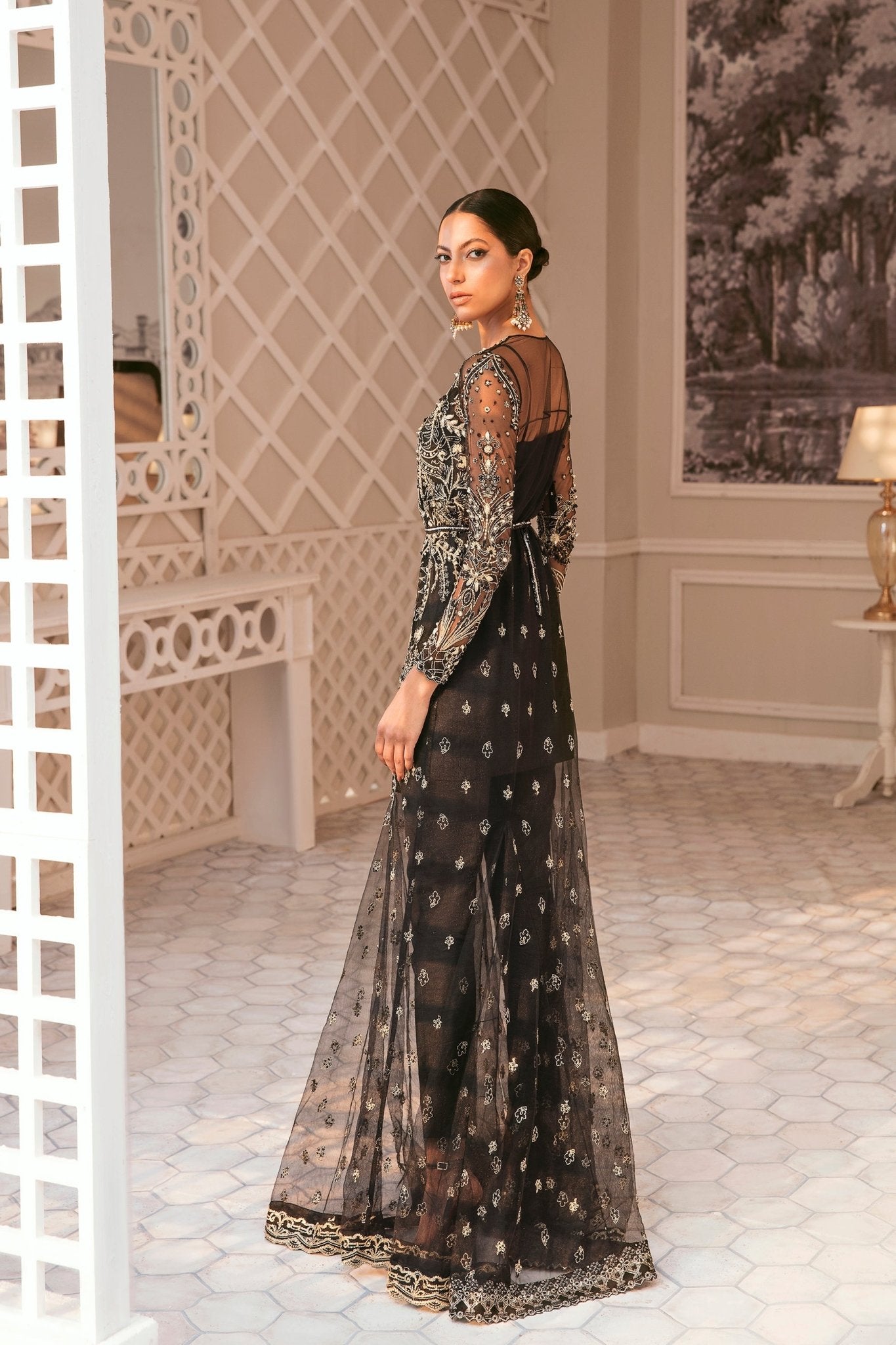 Model wearing a black wedding dress by Mysie by Tahira, adorned with intricate embellishments, ideal for Pakistani weddings, available online in the UK.