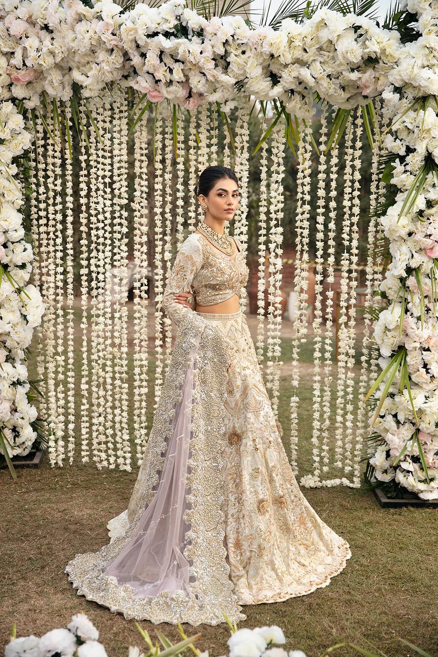 Model in a golden Mysie By Tahira Eshaal dress, epitome of luxe Pakistani bridal fashion in the UK.