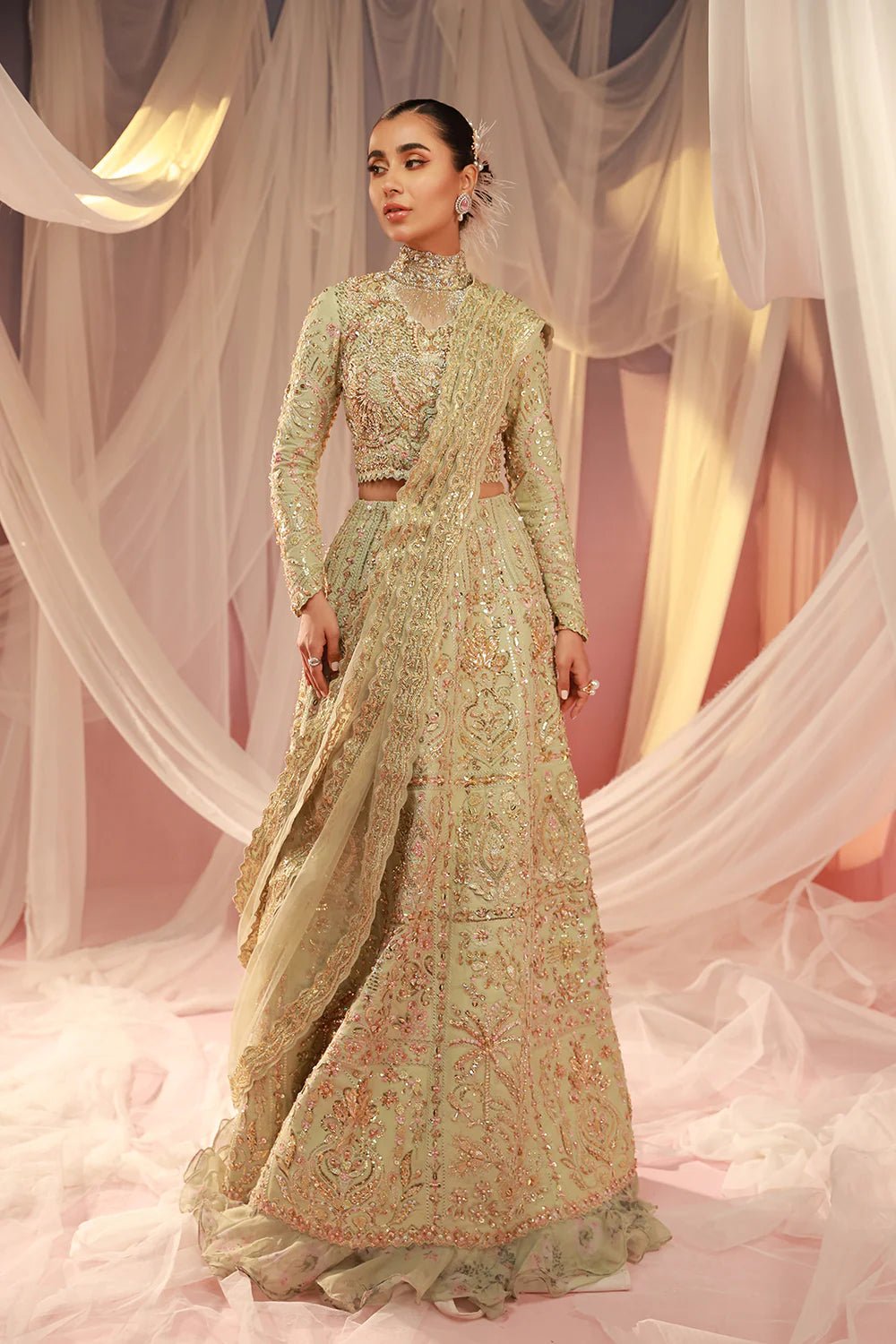 Model in Mysie By Tahira's Mahi dress, a pastel green bridal wear highlighting Pakistani clothes in the UK.