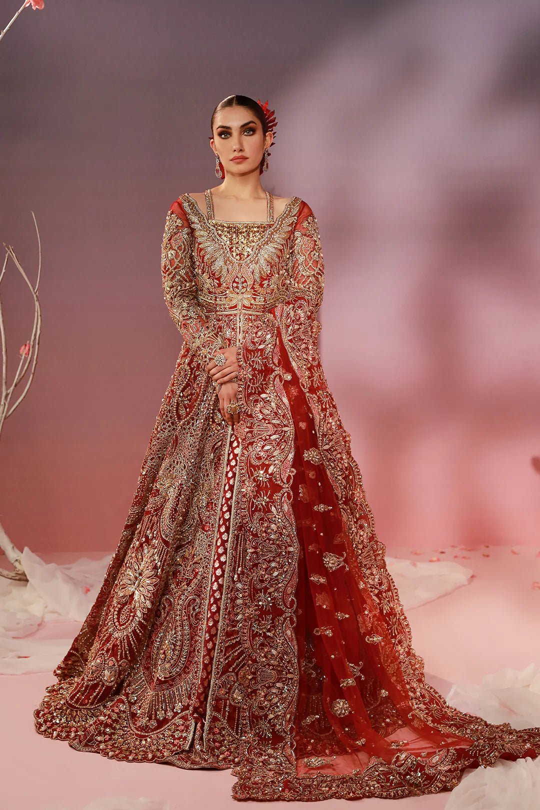 Model in a Mysie By Tahira red Naina bridal gown, exquisite Pakistani clothes in the UK.