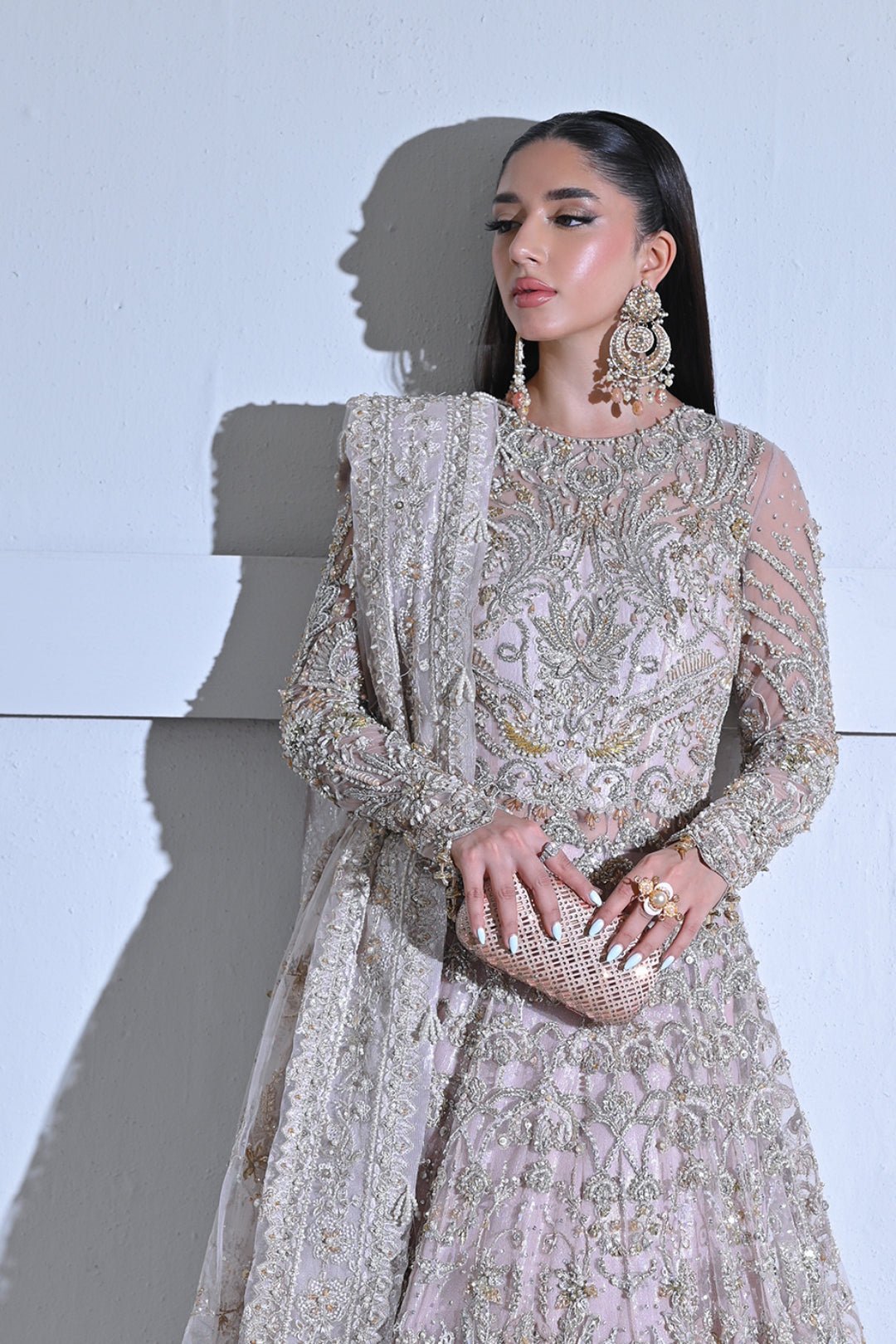 Model wearing Mysie by Tahira Poetique Bridals AFRIN, a pastel pink heavily embellished bridal dress, ideal for weddings. Available as Pakistani clothes online in the UK.