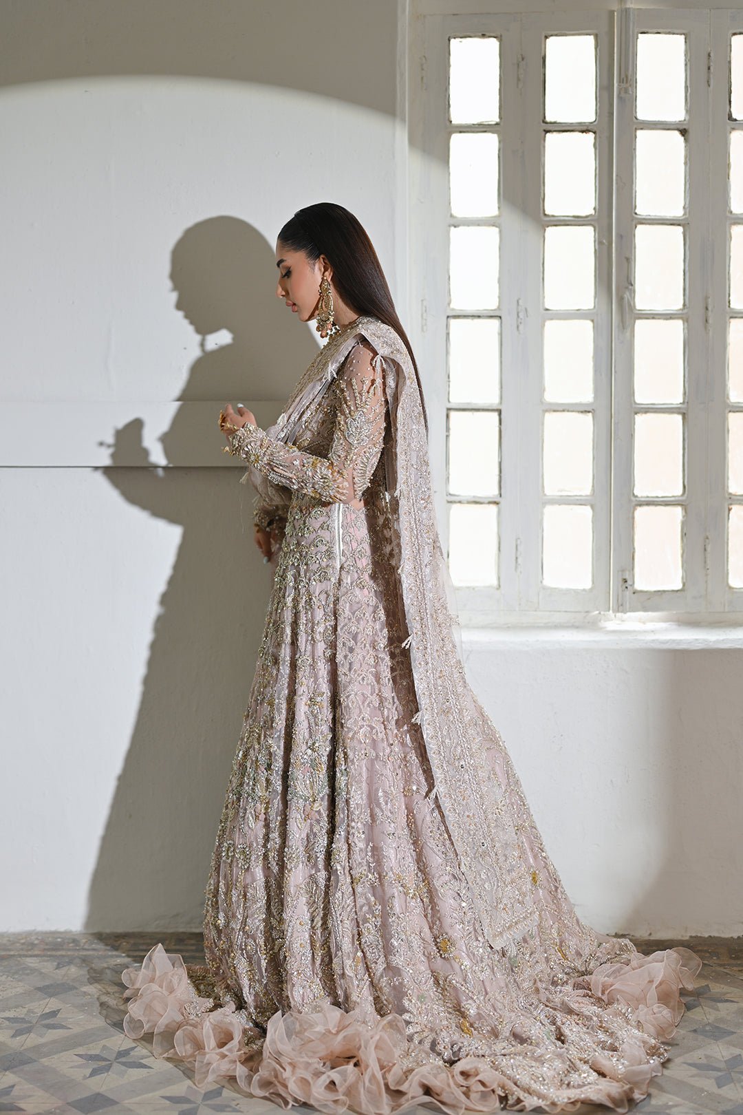 Model wearing Mysie by Tahira Poetique Bridals AFRIN, a pastel pink heavily embellished bridal dress, ideal for weddings. Available as Pakistani clothes online in the UK.