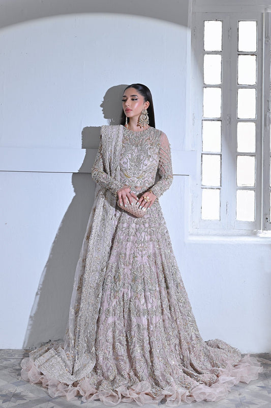 Model wearing Mysie by Tahira Poetique Bridals AFRIN, a pastel pink heavily embellished bridal dress, ideal for weddings. Available as Pakistani clothes online in the UK.