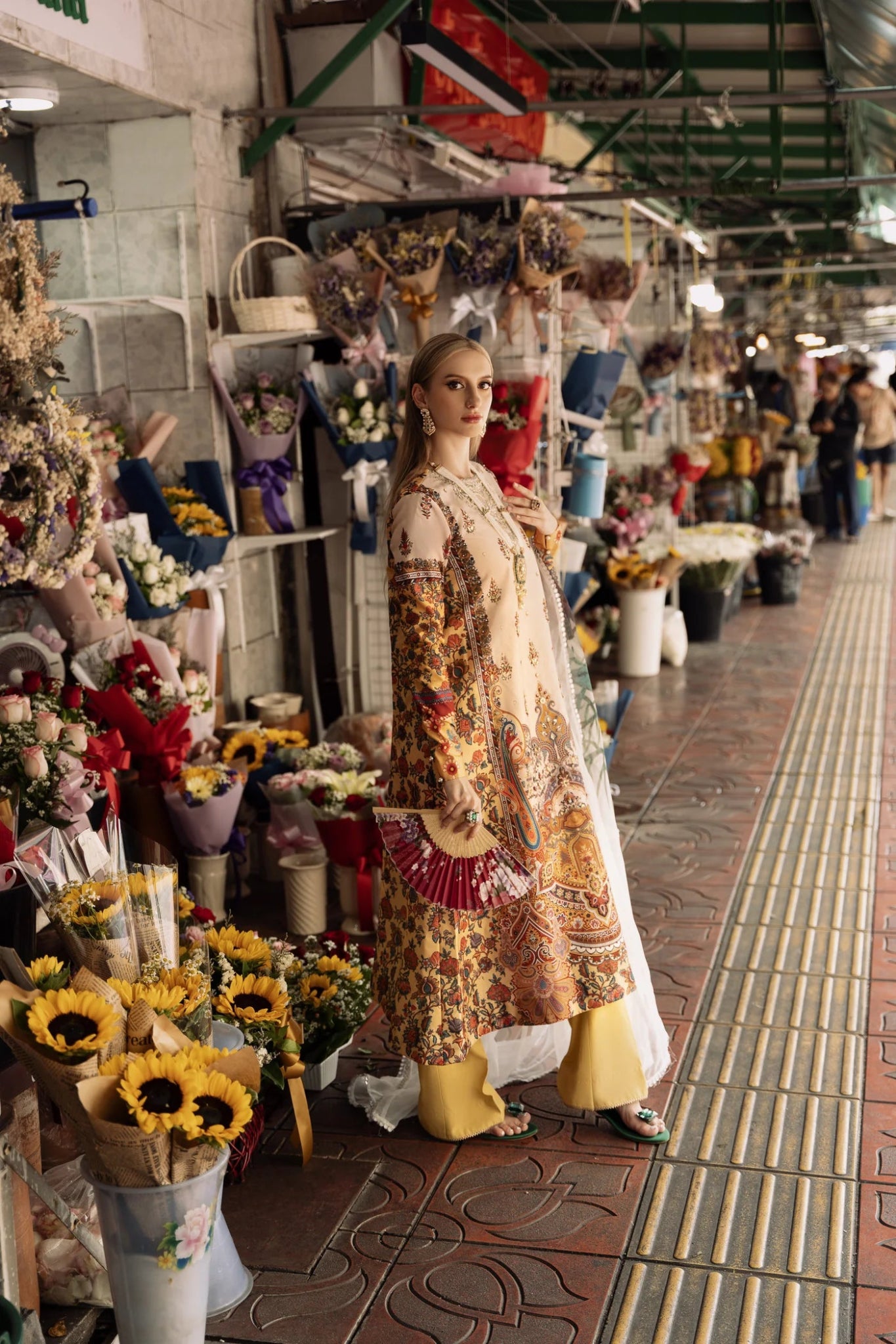 Model wearing beige EMAYA dress with vibrant patterns from Mysie By Tahira's Zenal Summer Pret collection, Pakistani designer clothes UK.