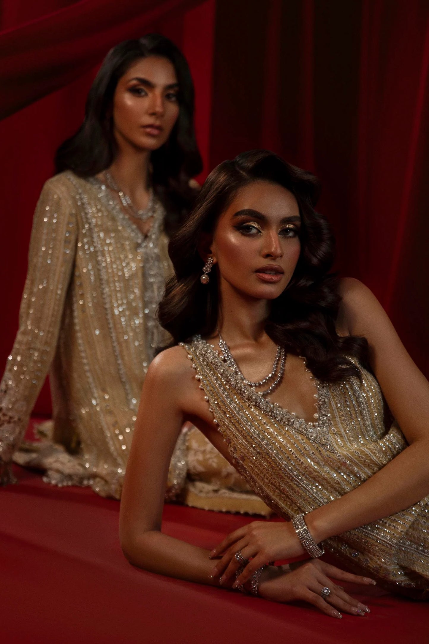 Model in Sana Safinaz gold NURA dress, highlighting luxury Pakistani attire for the UK market.