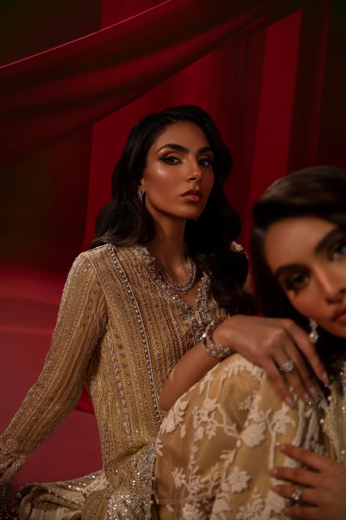 Model in Sana Safinaz gold NURA dress, highlighting luxury Pakistani attire for the UK market.