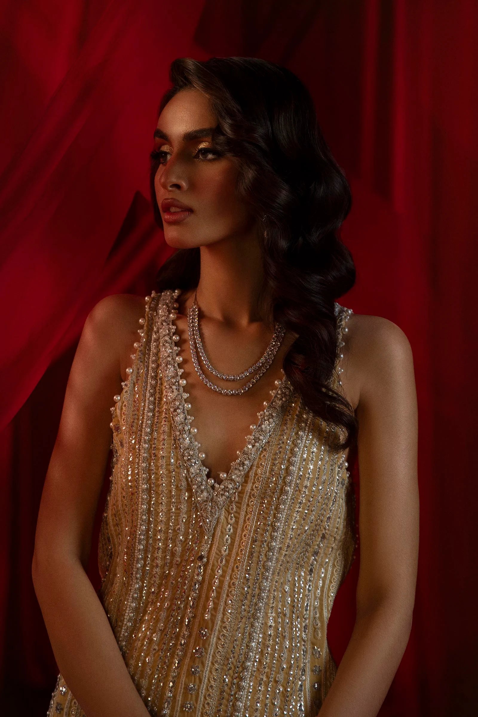 Model in Sana Safinaz gold NURA dress, highlighting luxury Pakistani attire for the UK market.