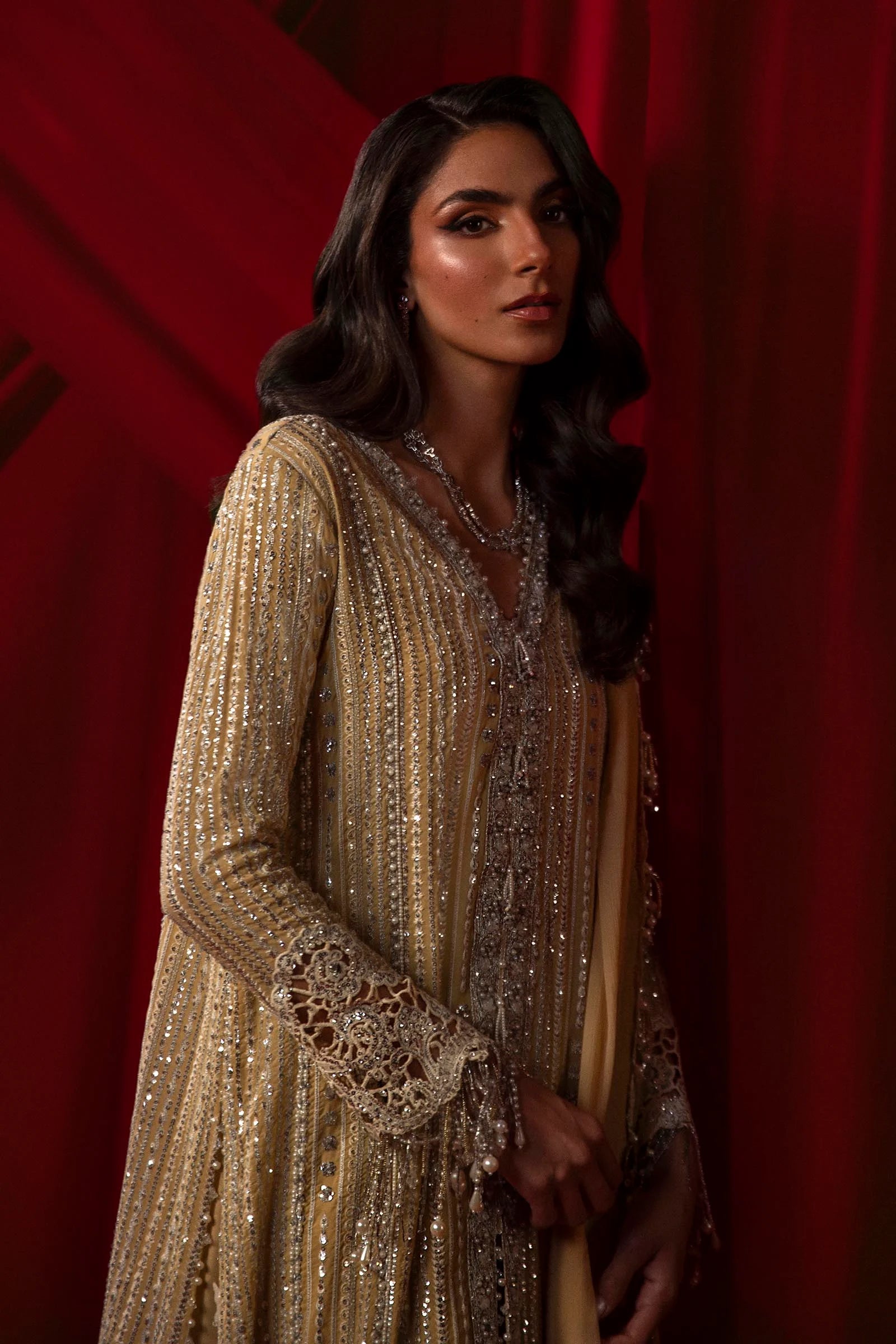 Model in Sana Safinaz gold NURA dress, highlighting luxury Pakistani attire for the UK market.