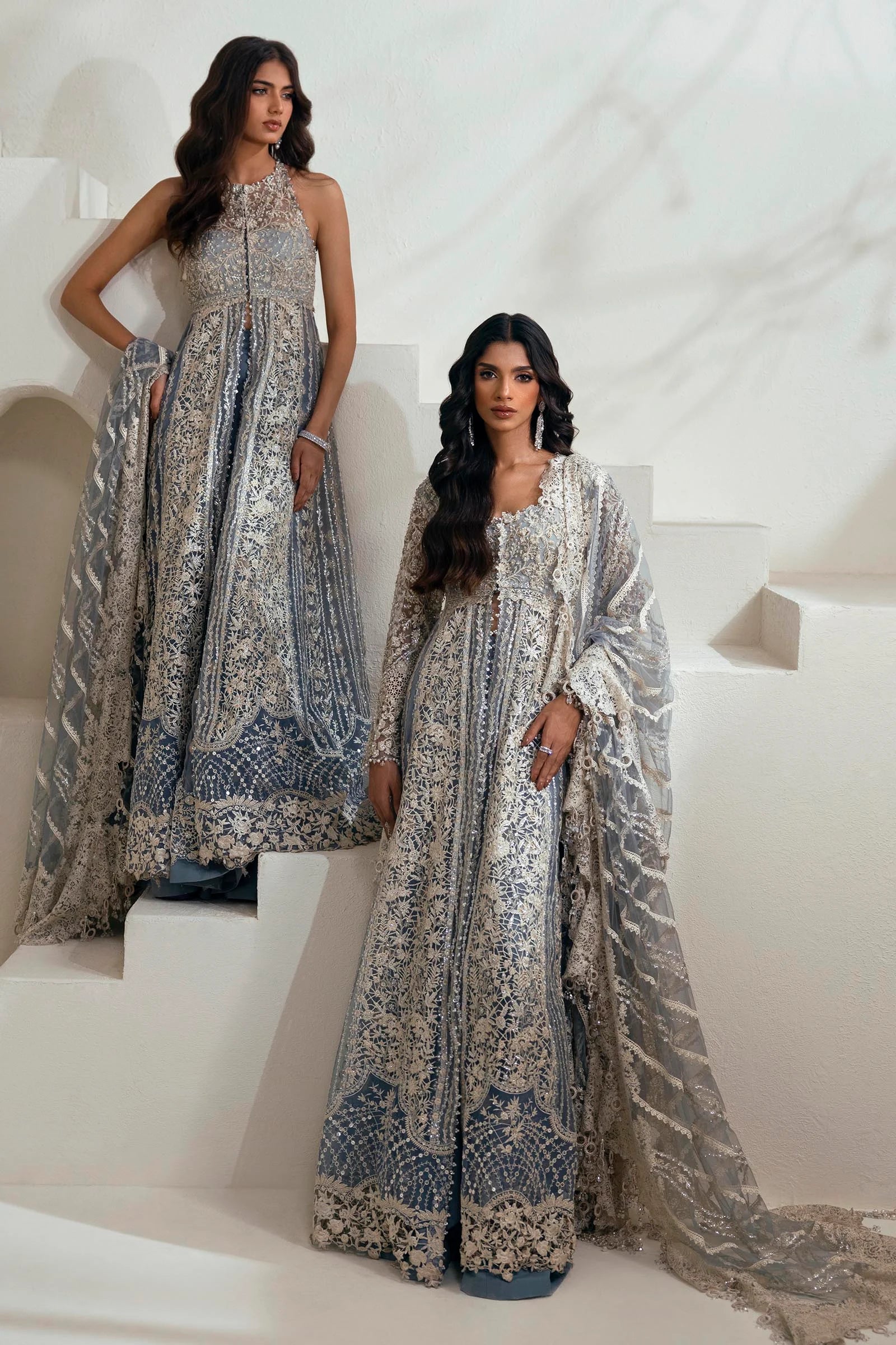 Model wearing N242 - 004 - 3CT dress from Sana Safinaz in a stunning blue color with intricate silver embroidery. Pakistani wedding clothes, available online in the UK.