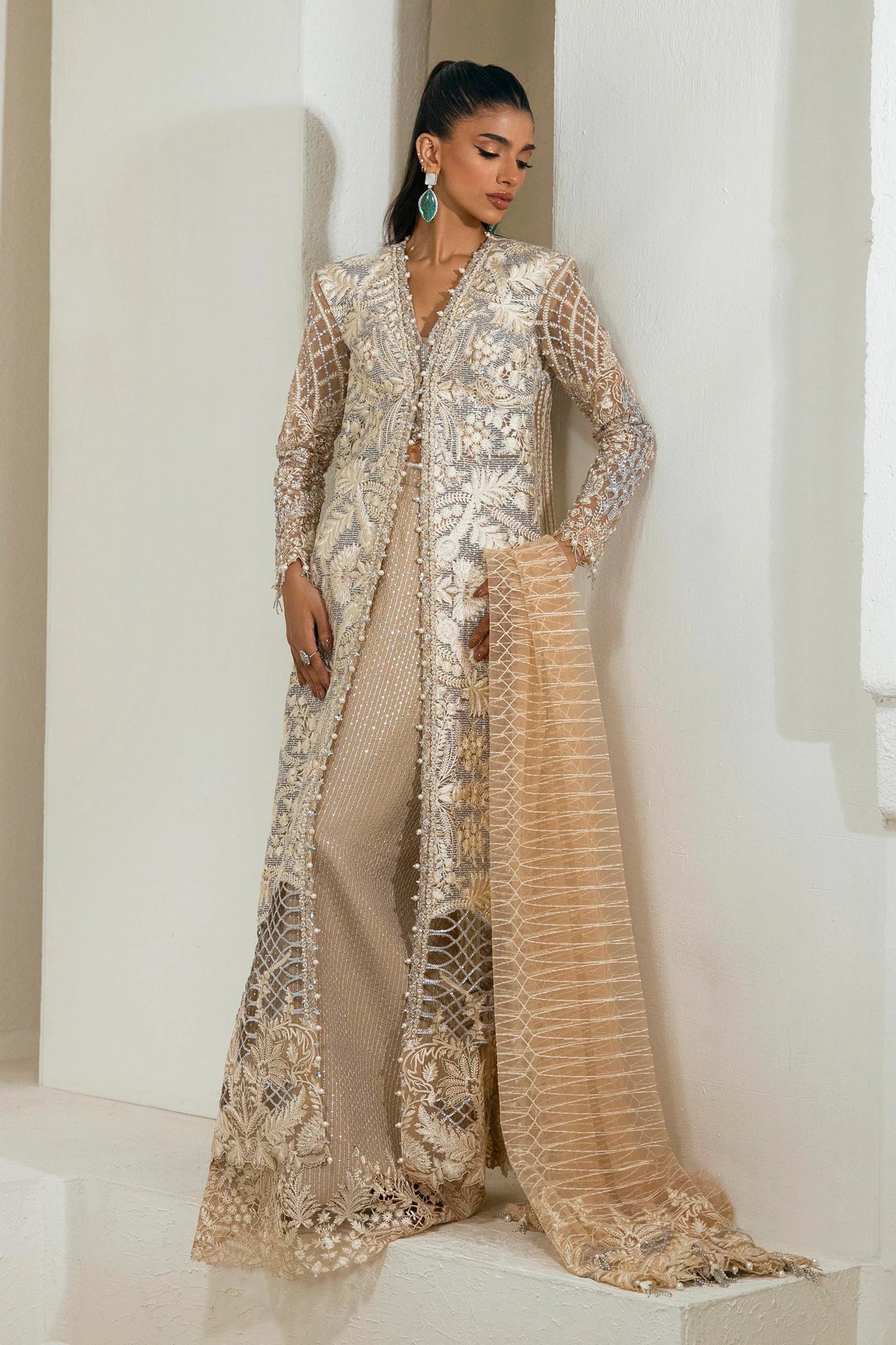 Model wearing an elegant N242 - 005 - 3CT dress in beige and gold from Sana Safinaz's NURA Festive '24 Vol. II collection. Available for Pakistani clothes online in UK, perfect for wedding clothes.