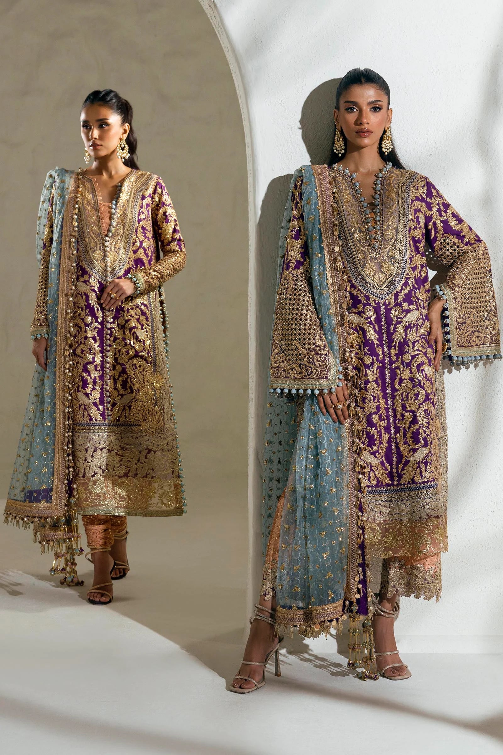 Model wearing a Sana Safinaz NURA Festive'24 Vol. II N242 - 007 - 3CX purple and gold embroidered dress with a blue dupatta. Perfect for Pakistani clothes online in UK, wedding clothes.