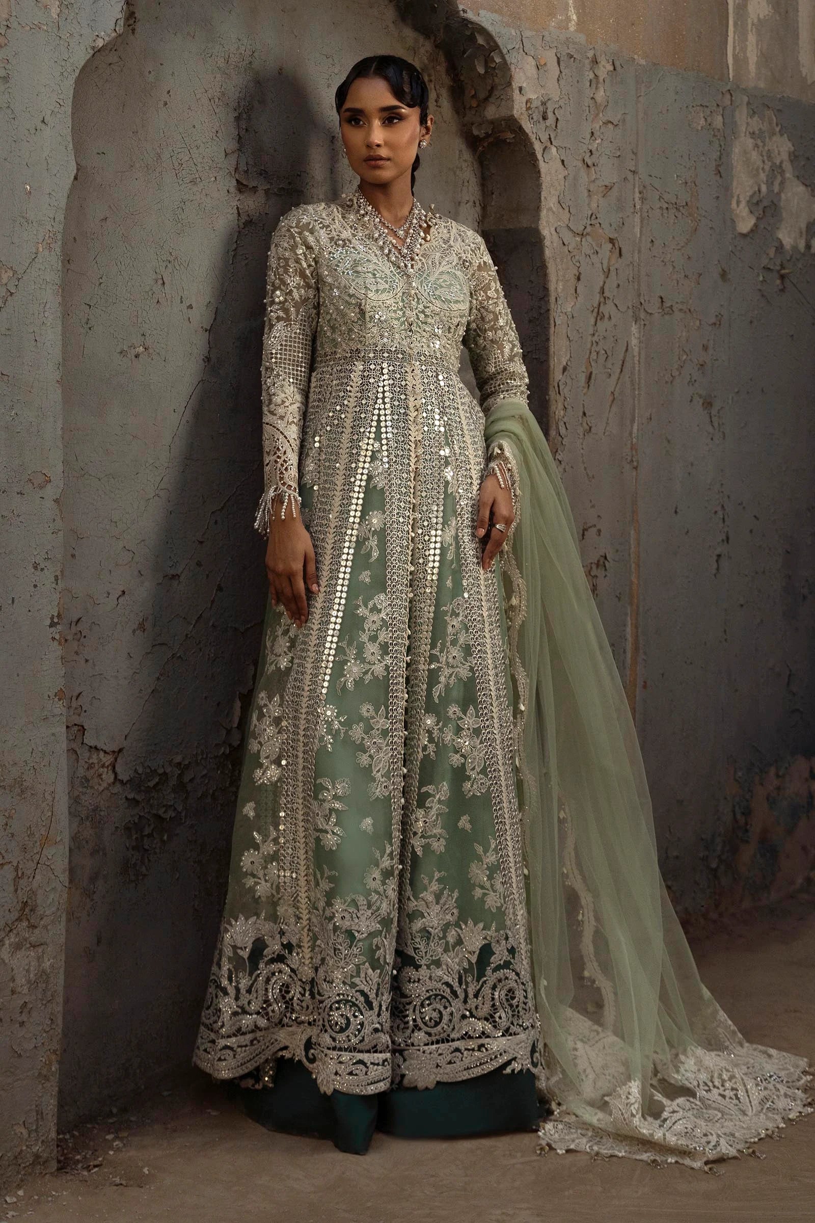 Model wearing mint green Sana Safinaz N251-005-3CX heavily embroidered gown with mirror work, Pakistani Luxury pret, Pakistani clothes online in UK.
