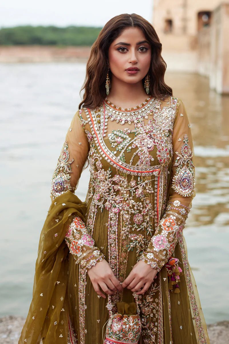 Model wearing Qalamkaar Shadmani Luxury Formals '24 Rameesha SH - 01 dress in olive green and deep red with intricate embroidery. Shop Pakistani bridal dresses online in the UK now.