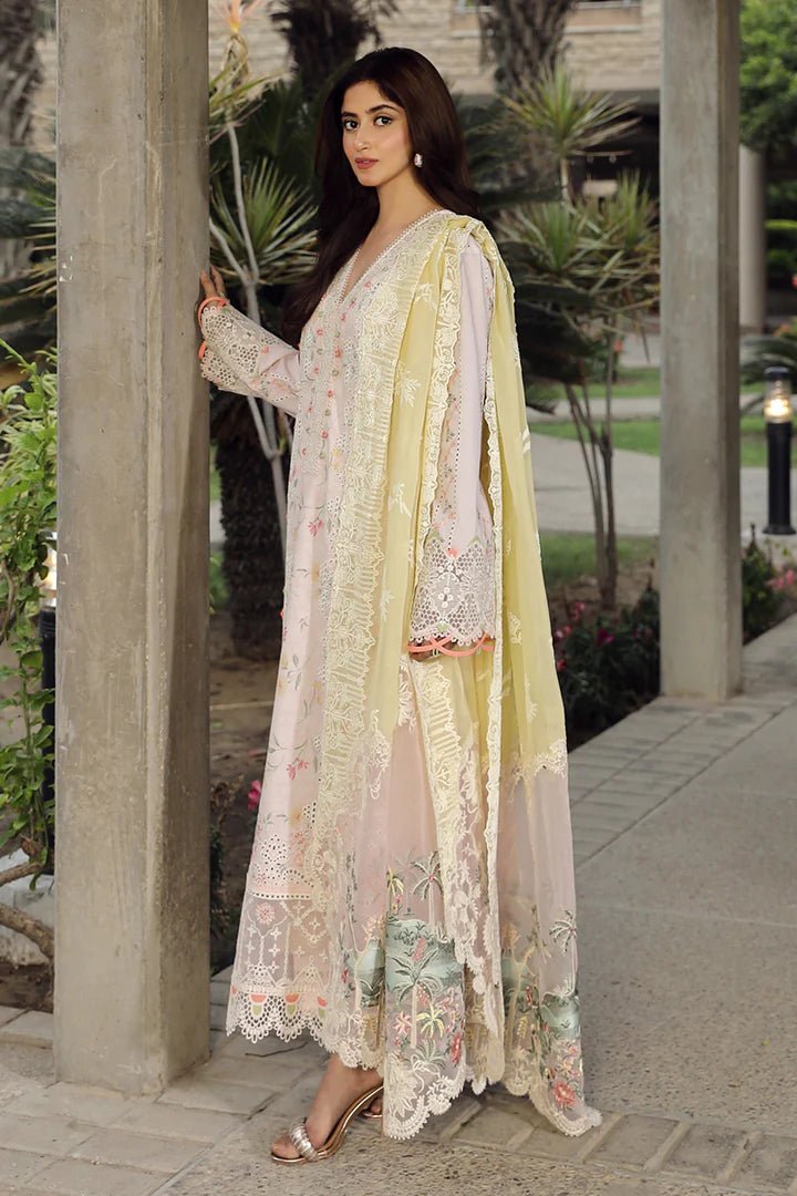 Model flaunting stunning IRSA dress by Qalamkar, ideal for Eid festivities. Discover Pakistani lawn dresses in the UK!