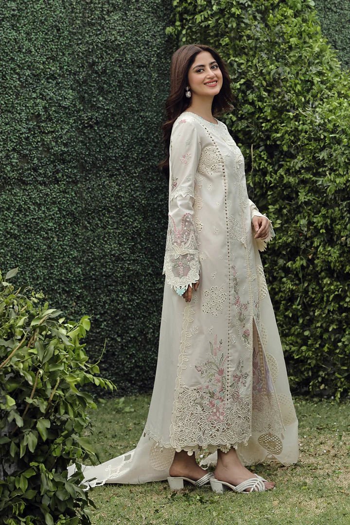 Model showcasing exquisite ZUHA dress by Qalamkar, perfect for Eid festivities. Discover Pakistani lawn dresses in the UK!