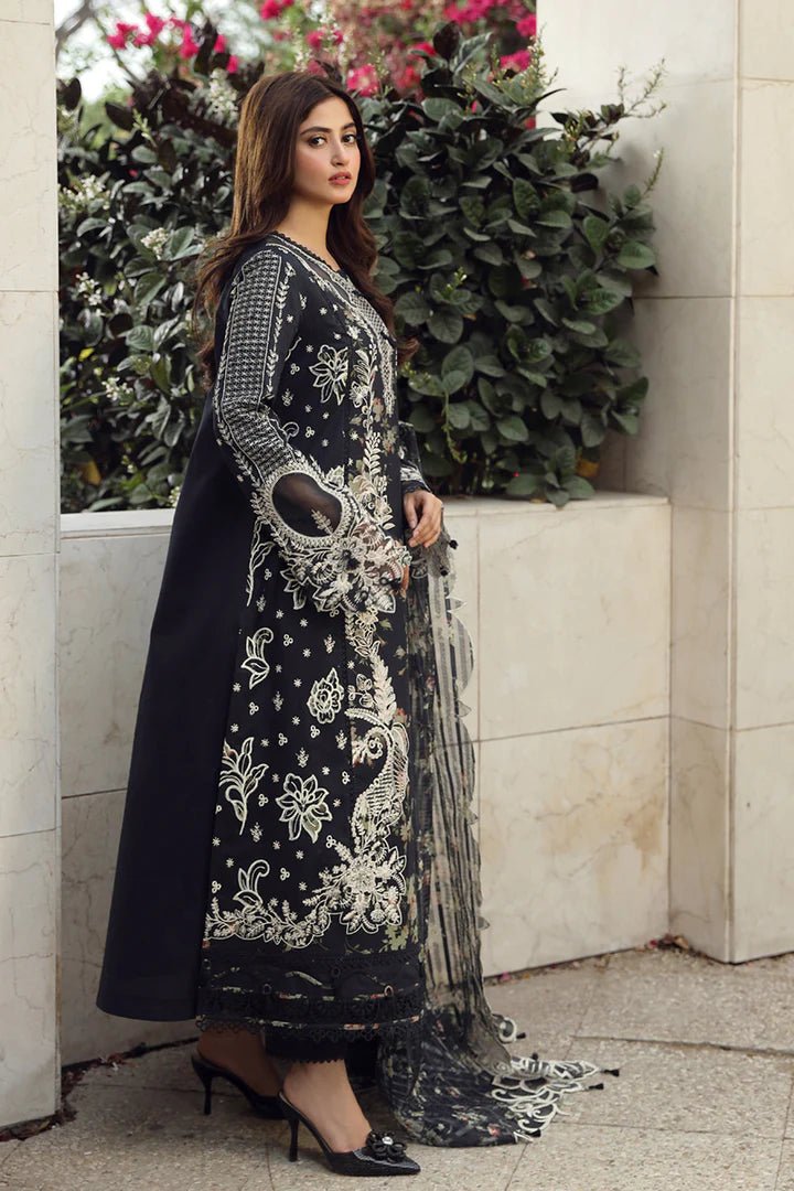 Model in exquisite black HAMNA dress by Qalamkar, perfect for Eid celebrations. Shop Pakistani lawn dresses in the UK!