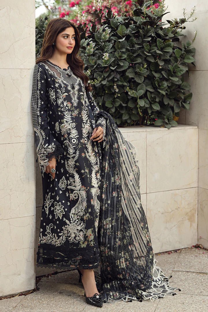 Model in exquisite black HAMNA dress by Qalamkar, perfect for Eid celebrations. Shop Pakistani lawn dresses in the UK!