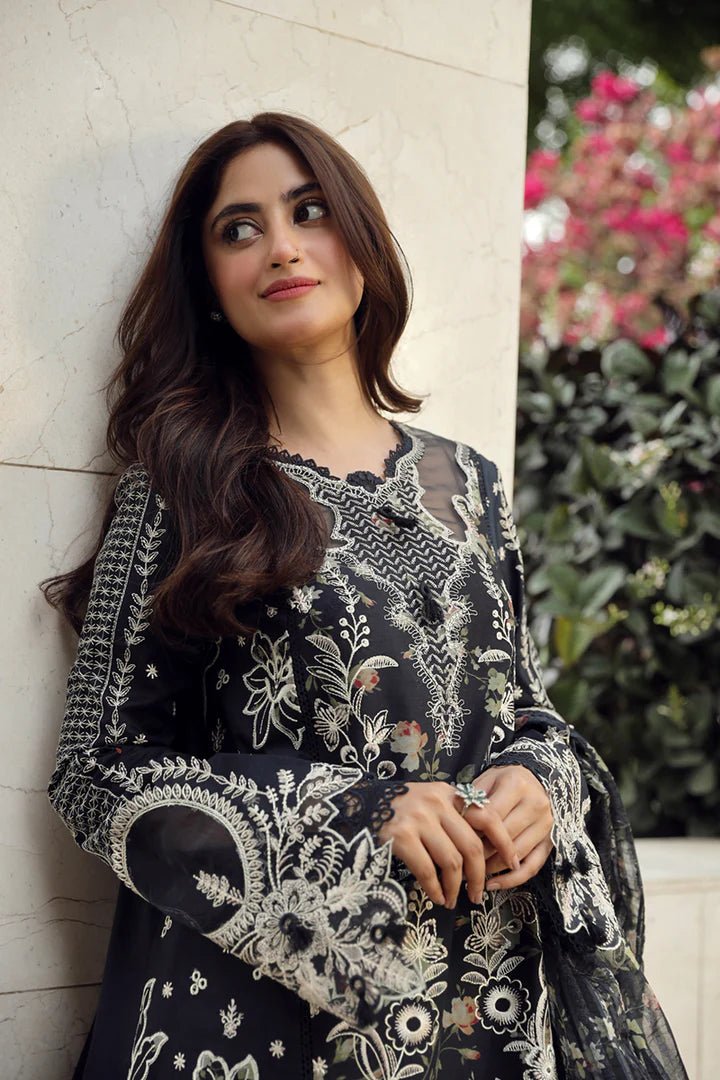 Model in exquisite black HAMNA dress by Qalamkar, perfect for Eid celebrations. Shop Pakistani lawn dresses in the UK!