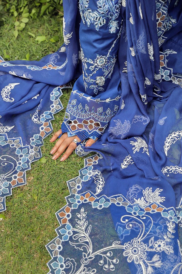 Model showcasing stunning BLUE FARHEEN dress by Qalamkar, perfect for Eid celebrations. Explore Pakistani lawn dresses in the UK!