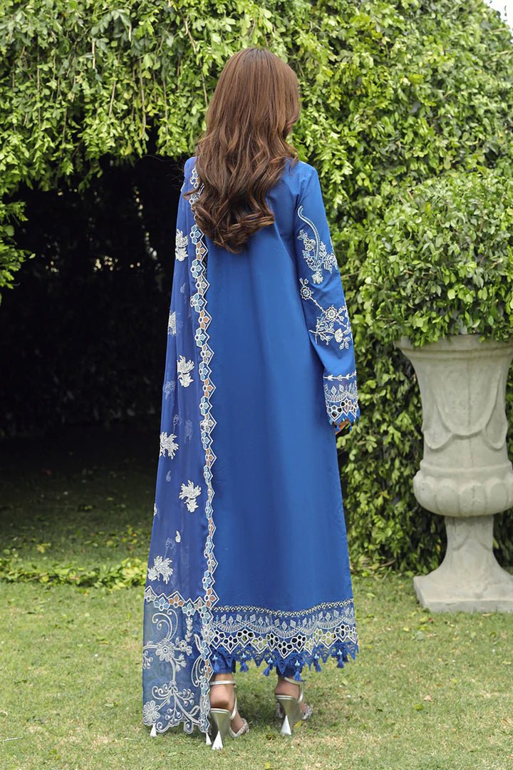 Model showcasing stunning BLUE FARHEEN dress by Qalamkar, perfect for Eid celebrations. Explore Pakistani lawn dresses in the UK!