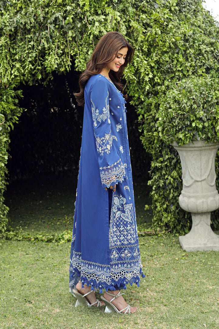 Model showcasing stunning BLUE FARHEEN dress by Qalamkar, perfect for Eid celebrations. Explore Pakistani lawn dresses in the UK!