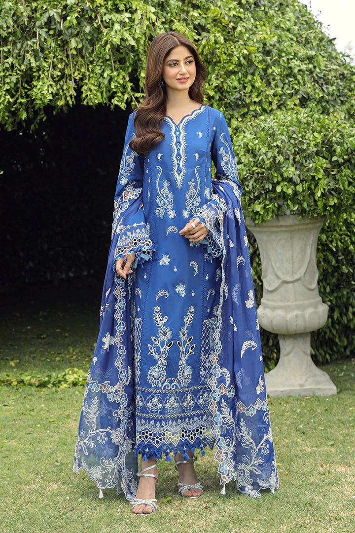 Model showcasing stunning BLUE FARHEEN dress by Qalamkar, perfect for Eid celebrations. Explore Pakistani lawn dresses in the UK!