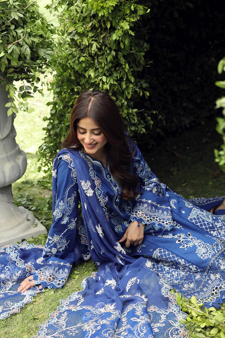 Model showcasing stunning BLUE FARHEEN dress by Qalamkar, perfect for Eid celebrations. Explore Pakistani lawn dresses in the UK!