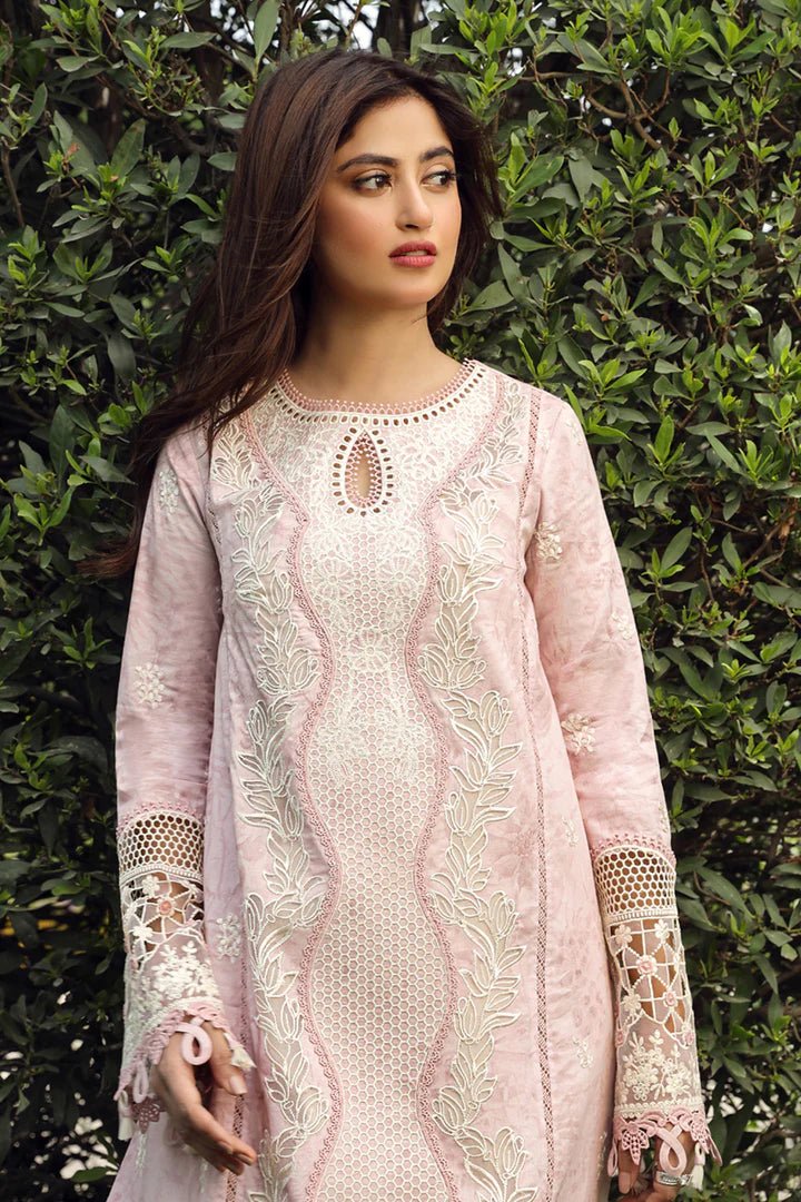 Model wearing Qalamkar Farva dress in soft pink with white embroidery, featuring elegant lace and detailed accents, perfect for Pakistani lawn dresses and Eid clothes in the UK.