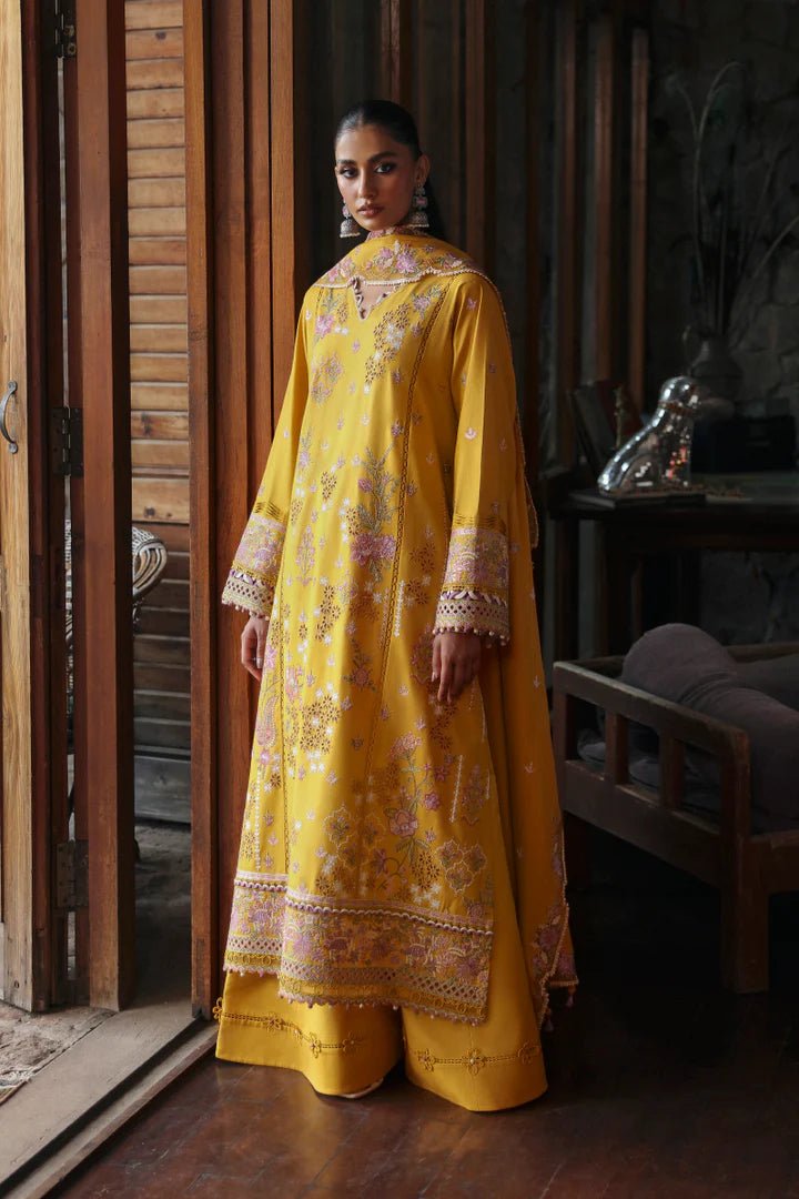 Model wearing LM - 04 SINSEAD dress from Qalamkar's Qlinekari Linen collection in mustard with intricate floral embroidery. Pakistani winter casual pret available online in the UK.