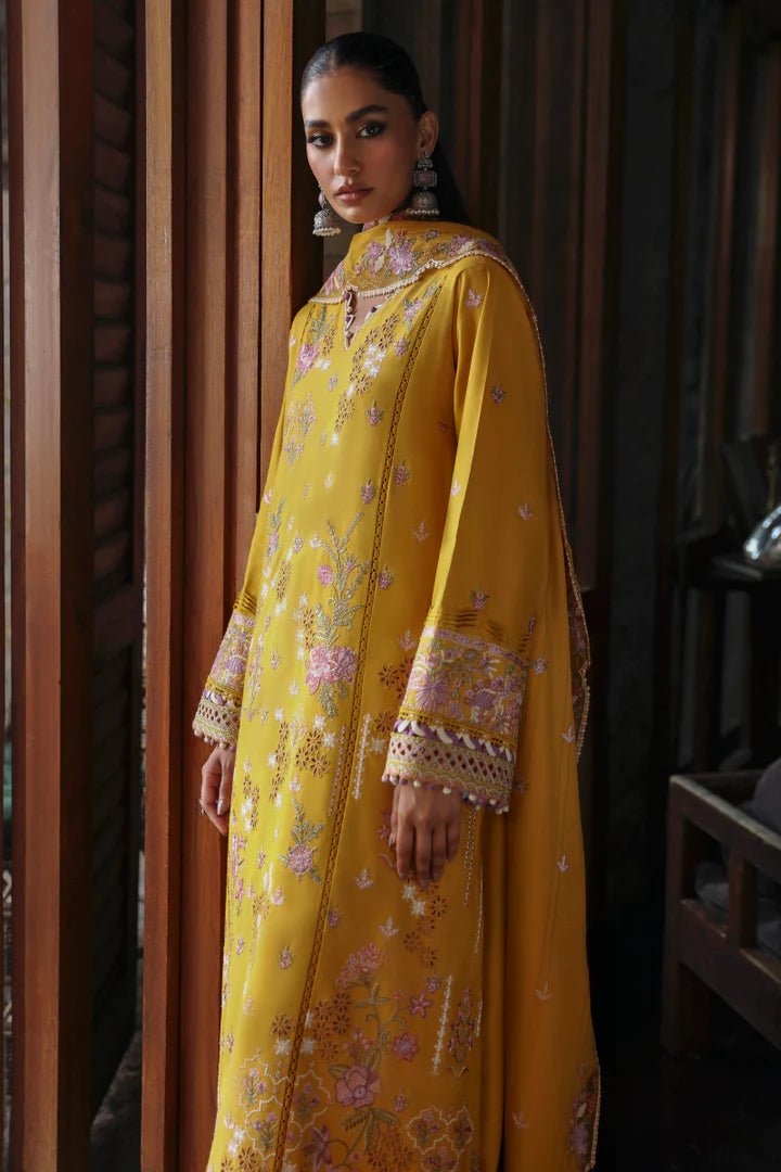 Model wearing LM - 04 SINSEAD dress from Qalamkar's Qlinekari Linen collection in mustard with intricate floral embroidery. Pakistani winter casual pret available online in the UK.