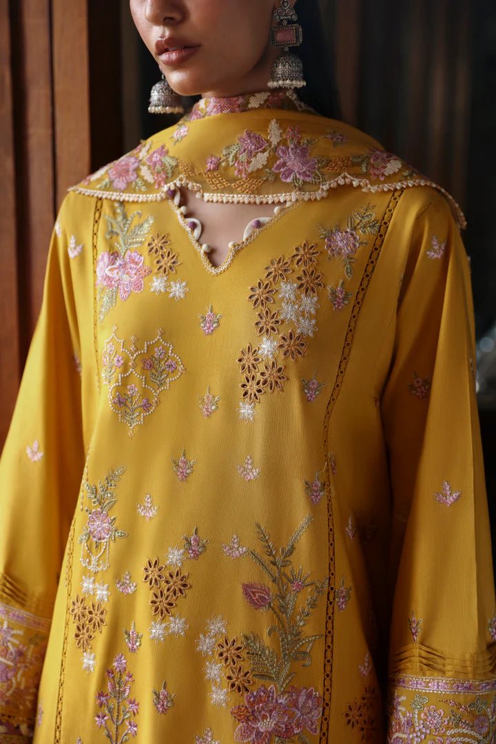 Model wearing LM - 04 SINSEAD dress from Qalamkar's Qlinekari Linen collection in mustard with intricate floral embroidery. Pakistani winter casual pret available online in the UK.