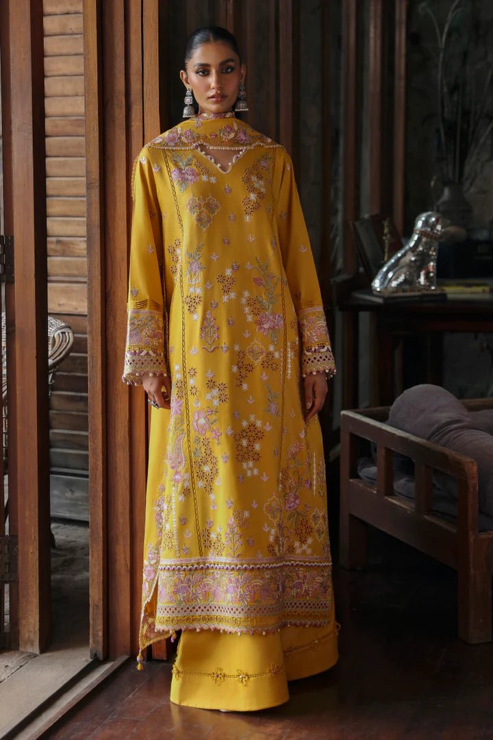 Model wearing LM - 04 SINSEAD dress from Qalamkar's Qlinekari Linen collection in mustard with intricate floral embroidery. Pakistani winter casual pret available online in the UK.