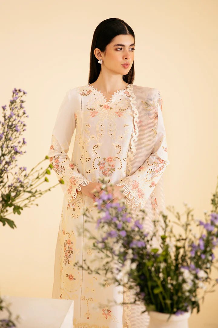 Model wearing cream SQ - 01 SARV dress from Qalamkar, featuring delicate floral embroidery and intricate lace detailing. Ideal for Pakistani designer clothes in the UK, readymade clothing, and luxurious lawn collections.