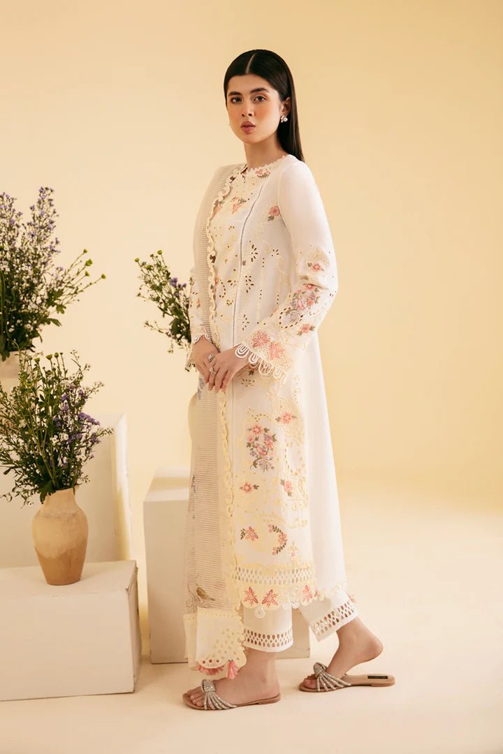 Model wearing cream SQ - 01 SARV dress from Qalamkar, featuring delicate floral embroidery and intricate lace detailing. Ideal for Pakistani designer clothes in the UK, readymade clothing, and luxurious lawn collections.