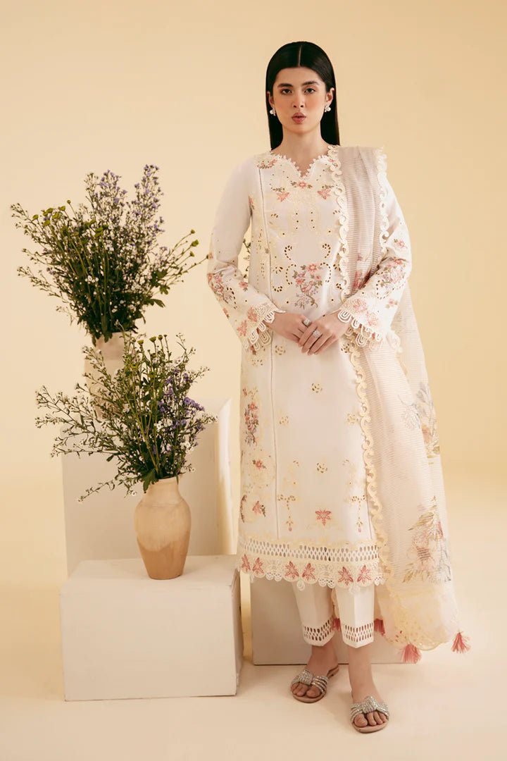 Model wearing cream SQ - 01 SARV dress from Qalamkar, featuring delicate floral embroidery and intricate lace detailing. Ideal for Pakistani designer clothes in the UK, readymade clothing, and luxurious lawn collections.