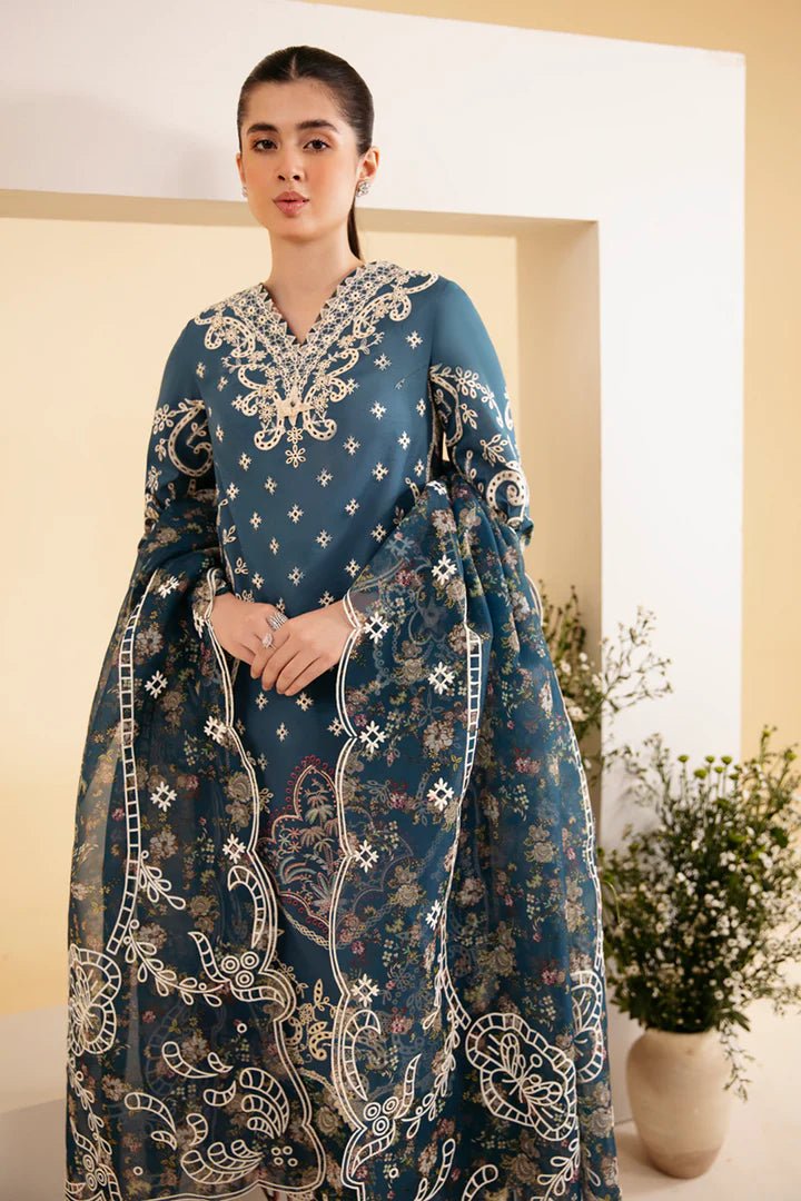 Model wearing blue SQ - 05 ELA dress from Qalamkar, featuring intricate embroidery and floral patterns. Ideal for Pakistani designer clothes in the UK, readymade clothing, and luxurious lawn collections.