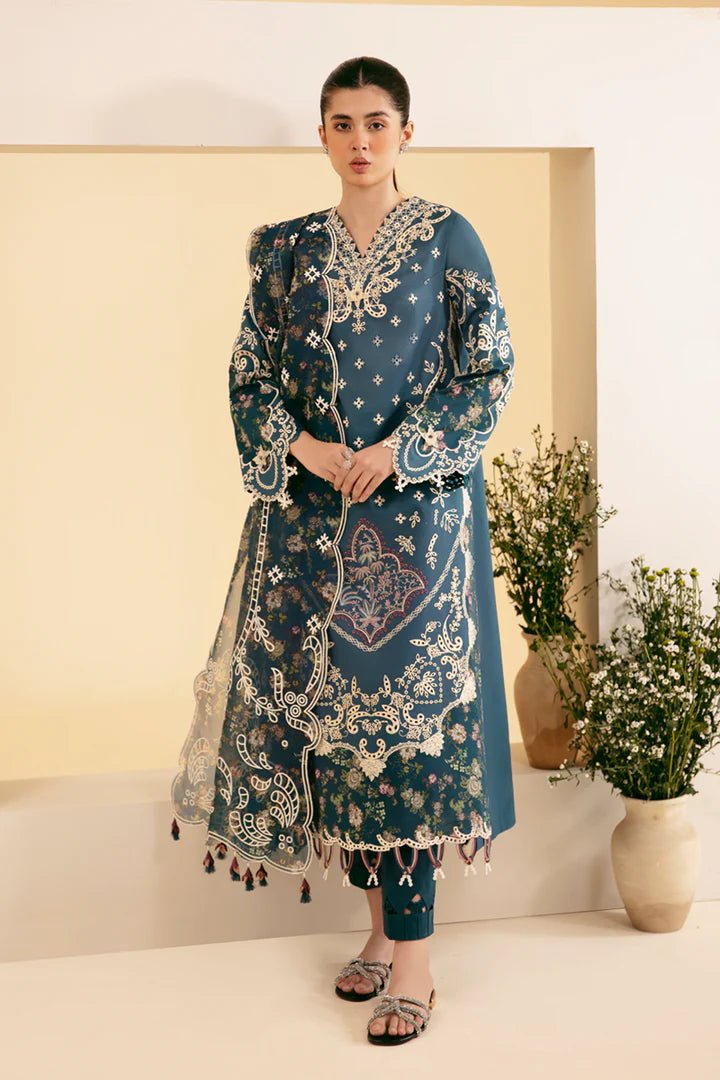 Model wearing blue SQ - 05 ELA dress from Qalamkar, featuring intricate embroidery and floral patterns. Ideal for Pakistani designer clothes in the UK, readymade clothing, and luxurious lawn collections.