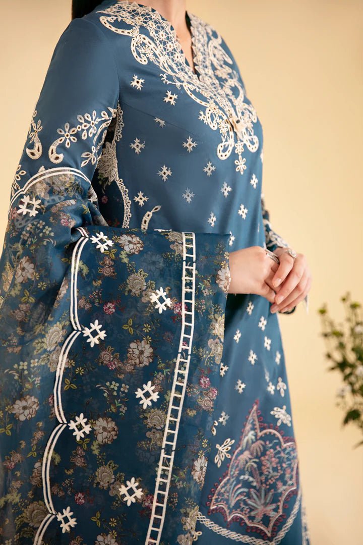 Model wearing blue SQ - 05 ELA dress from Qalamkar, featuring intricate embroidery and floral patterns. Ideal for Pakistani designer clothes in the UK, readymade clothing, and luxurious lawn collections.