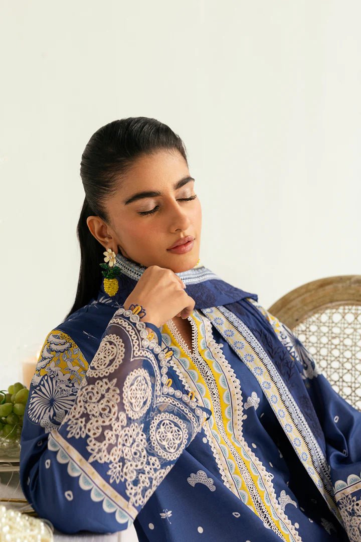 Model wearing blue and yellow PQ - 02 Hina dress from Qalamkar, a stylish Pakistani lawn suit perfect for eid and summer clothes in the UK.