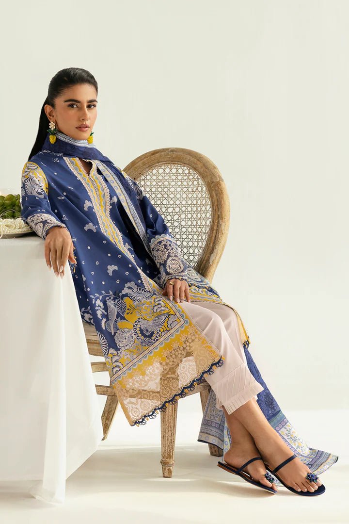 Model wearing blue and yellow PQ - 02 Hina dress from Qalamkar, a stylish Pakistani lawn suit perfect for eid and summer clothes in the UK.