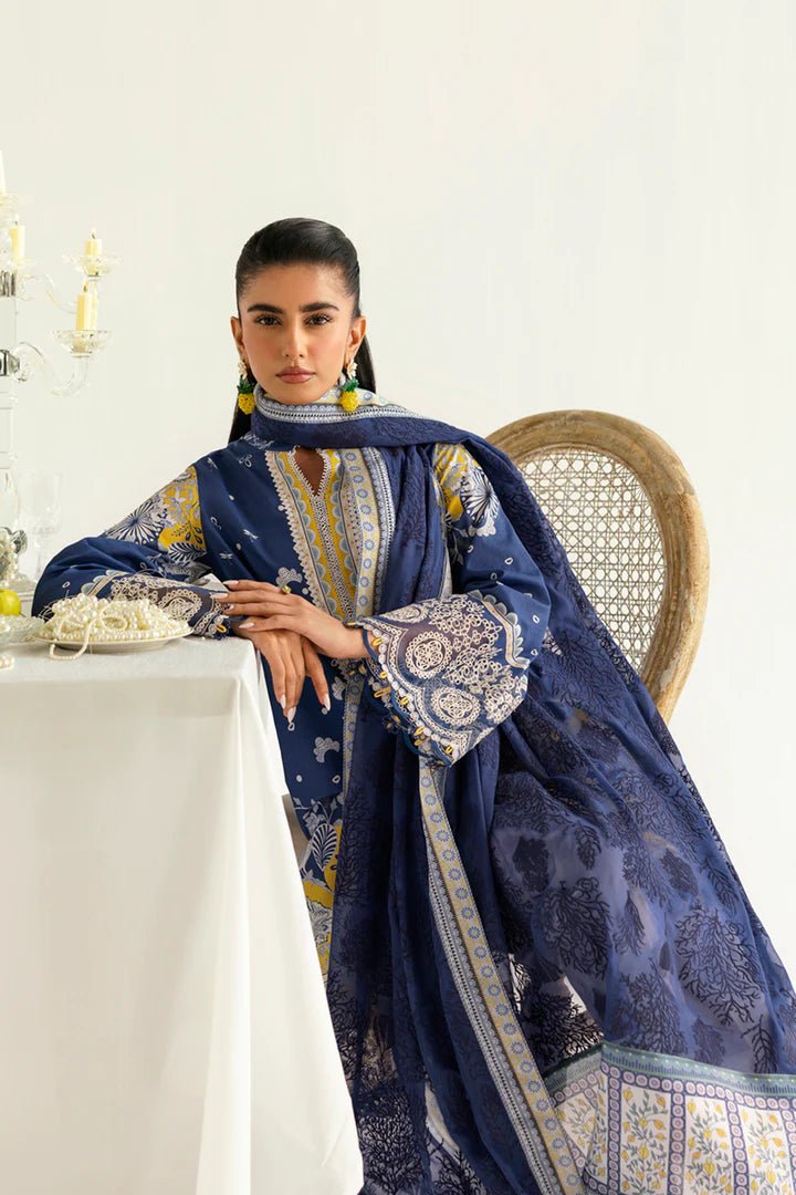 Model wearing blue and yellow PQ - 02 Hina dress from Qalamkar, a stylish Pakistani lawn suit perfect for eid and summer clothes in the UK.