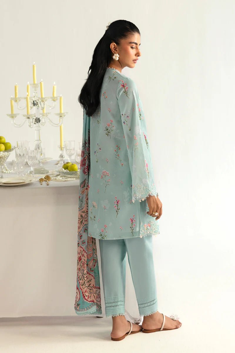 Model wearing Qalamkar Qprints '25 PQ - 08 Rena dress in pastel mint green with delicate floral embroidery. Shop Pakistani clothes online in the UK now.