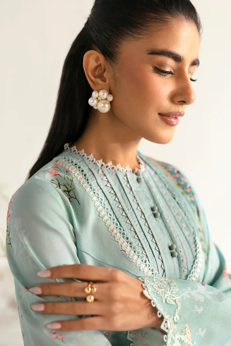 Model wearing Qalamkar Qprints '25 PQ - 08 Rena dress in pastel mint green with delicate floral embroidery. Shop Pakistani clothes online in the UK now.