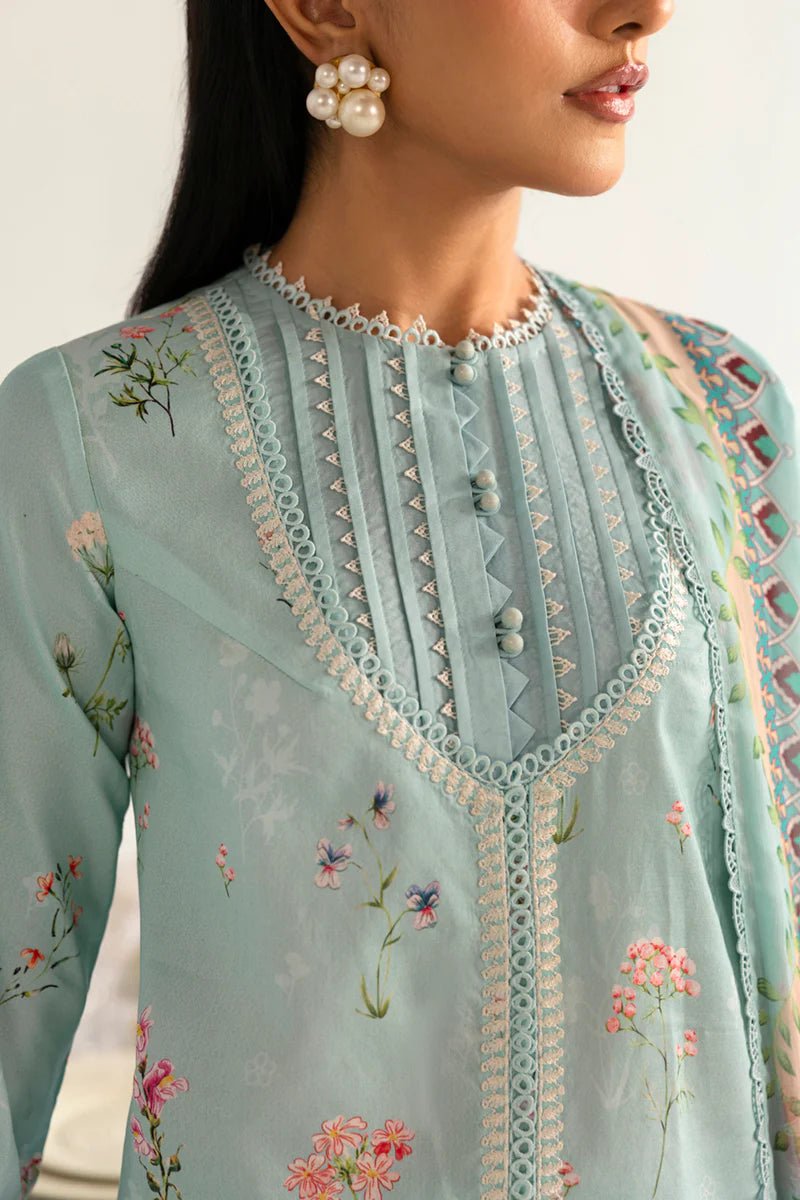 Model wearing Qalamkar Qprints '25 PQ - 08 Rena dress in pastel mint green with delicate floral embroidery. Shop Pakistani clothes online in the UK now.